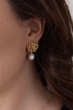 Glamour and beauty, jewelry and luxury concept - close up of beautiful woman face with pearl earring