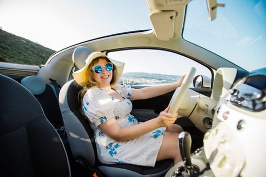 Young woman drive and having fun in cabrio against beach and sea - travel and summer voyage nature concept