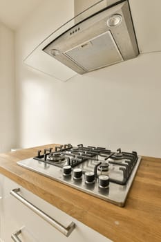a kitchen with a stove top oven and a sink