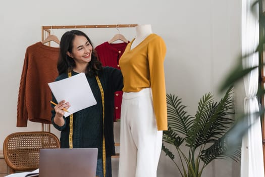 Female stylist Successful Fashion Business. Portrait of Smiling Asian Designer stylish standing and working at fashion studio. Portrait of fashion designer in office