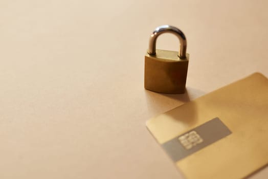 Is your credit card secure. Studio shot of a credit card and lock against a brown background.