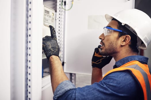 Man, phone call and engineering in control room, switchboard or industrial system inspection. Male electrician talking on smartphone at power box, server mechanic or electrical substation maintenance