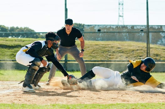 Its a game that takes discipline to win. a young baseball player reaching base during a match on the field.