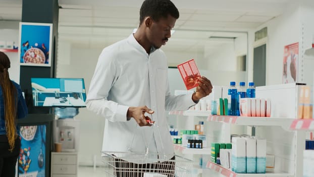 Male customer taking vitamins box from drugstore