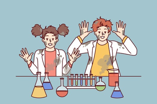 Funny children in laboratory raise hands after unexpected reaction when mixing chemical reagents