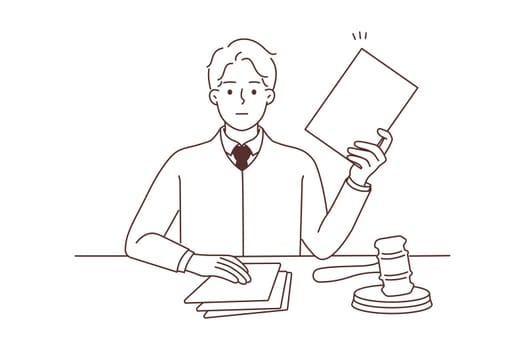 Male lawyer with documents sit at desk