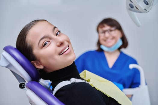 Young teenage female on dental examination treatment in clinic