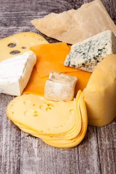 Different type of cheese on wooden background