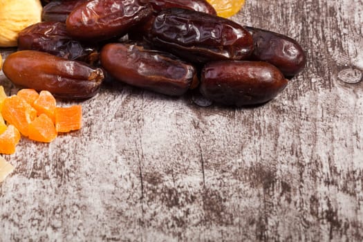 Mix of different dried fruits on wooden background