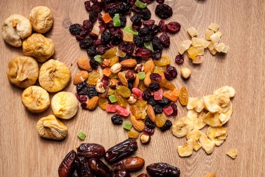 Mix of dried fruits on wooden background