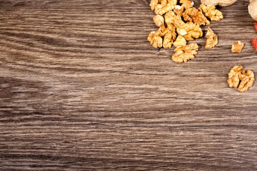 Raw organic food and nuts on wooden background