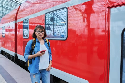 Woman passenger of urban rail transport at modern train station