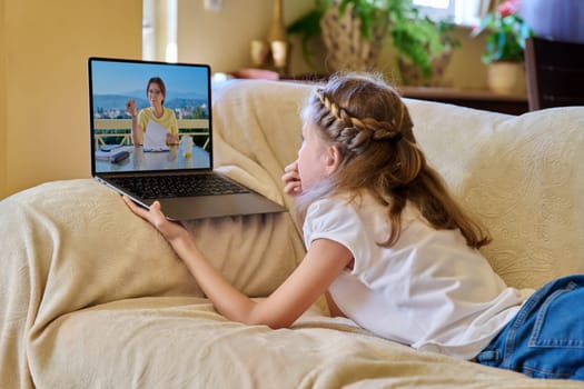 Online meeting of preteen girl with mentor, child psychologist at home on couch