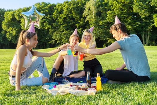 Teenage birthday party picnic on the grass in the park
