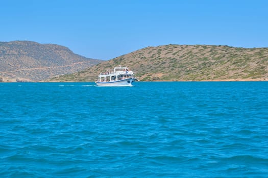 09.09.2019. Greece Crete. Tourist motor boat cruise, blue aegean sea background, greek islands