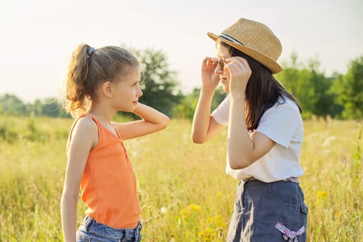 Children are having fun in nature, two girls laugh