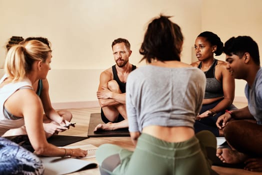 Yoga class, where your inner circle brings you inner peace. a group of young men and women chatting during a yoga class