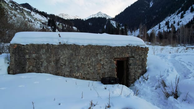 An old stone prison or hut in the mountains.