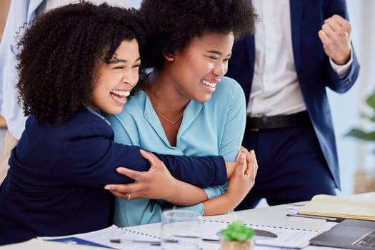 Business woman, friends and hugging in congratulations for promotion, sale or bonus at the office desk. Women hug in celebration for corporate success, teamwork or support for winning or achievement.