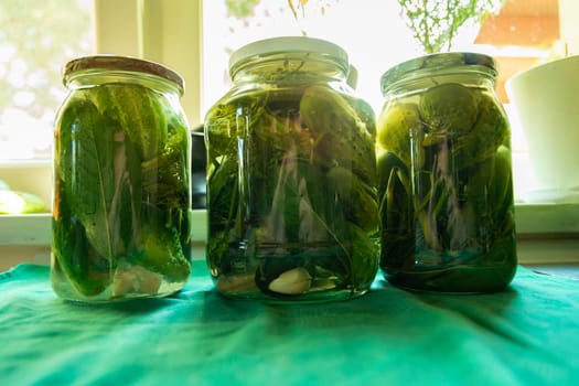 Close-up of canned fresh homemade cucumbers in glass jars