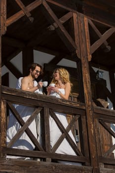 couple drinking coffee on the balcony