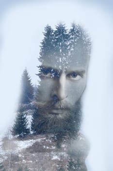 Fashion artistic double exposure image of bearded hipster on winter mountains background