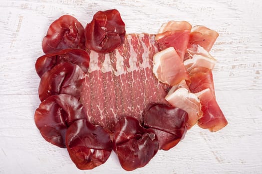 Delicoius italian ham on wooden background