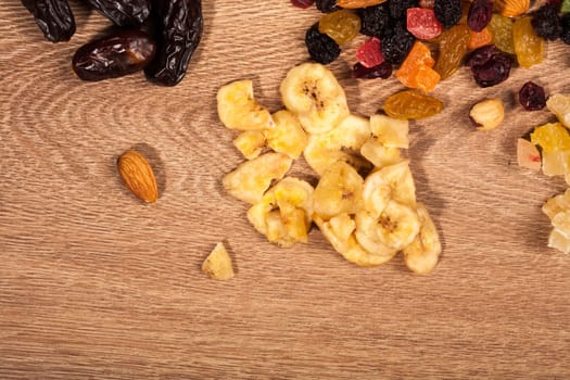 Different type of dried fruits on wooden background