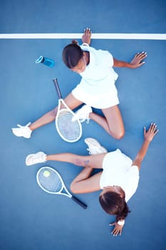 Top view, tennis and women tired, conversation and exhausted after match, training and happiness for sport. Female athletes, players or friends with rackets, workout or practice for healthy lifestyle.
