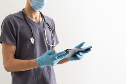Young male doctor holding tablet with medical health concept
