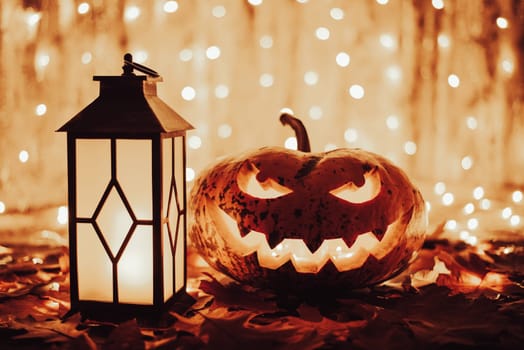 Beautiful pumpkin with lantern on Autumn leaves