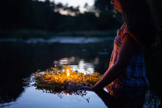 Young girl holding wreath with burning candle