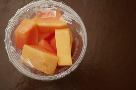 fresh papaya in a plastic container