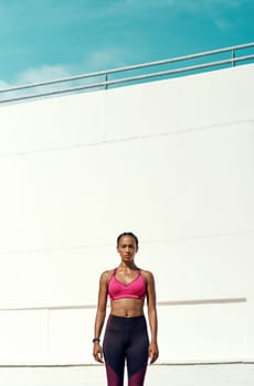 Fight your laziness and everything else will fall into place. an attractive young woman standing outside in sportswear.