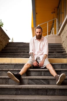 Tattoed and bearded hipster posing outdoor