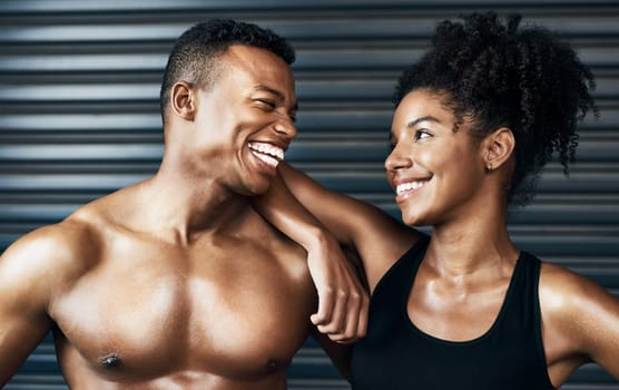 Im glad to have you as a workout partner. a sporty young couple standing together against a grey background.