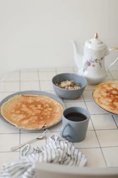 Stack of crepes on kitchen table. Pancakes for breakfast, food photography