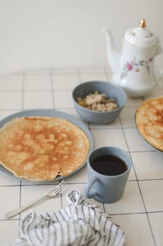 Stack of crepes on kitchen table. Pancakes for breakfast, food photography