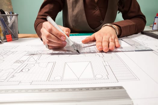 Close up of architect working on blueprints