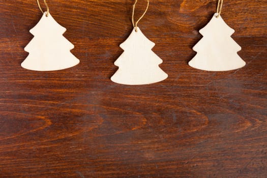 Three wooden tree on wooden background