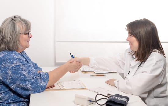doctor shaking hands with her patient before the consultation