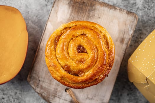 Fresh baked sweet swirl bun roll on serving board