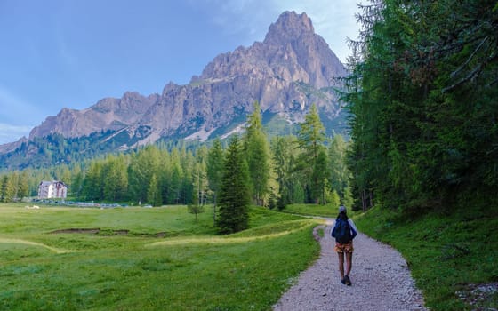 young women hiking at the dolomites mountains in Italy