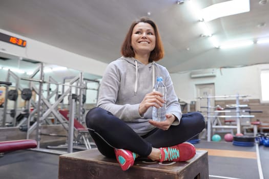Portrait of middle-aged beautiful woman in gym