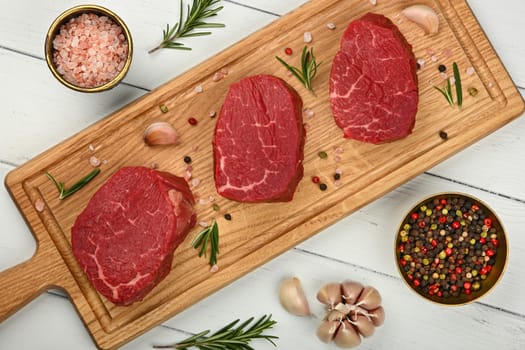Close up raw beef tenderloin steak on board