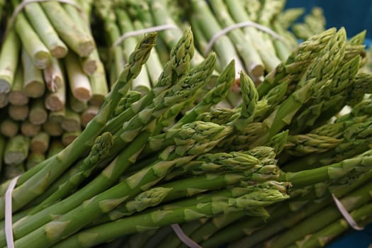 Heap of fresh green asparagus shoots close up