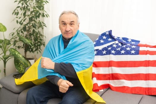 Mature man with flag of Ukraine and usa flag