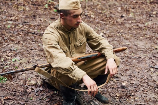 TERNOPIL, UKRAINE - June 2020 UPA Ukrainian Insurgent Army movie filming. Pictures of backstage. Soldier with weapon sitting in the forest