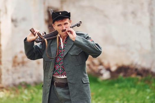 TERNOPIL, UKRAINE - June 2020 UPA Ukrainian Insurgent Army movie filming. Pictures of backstage. Old soldier with weapon smoking