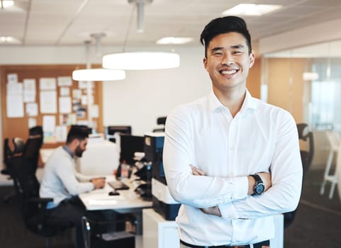 For me, happiness means success. Cropped portrait of a handsome young businessman standing with his arms folded in the office.